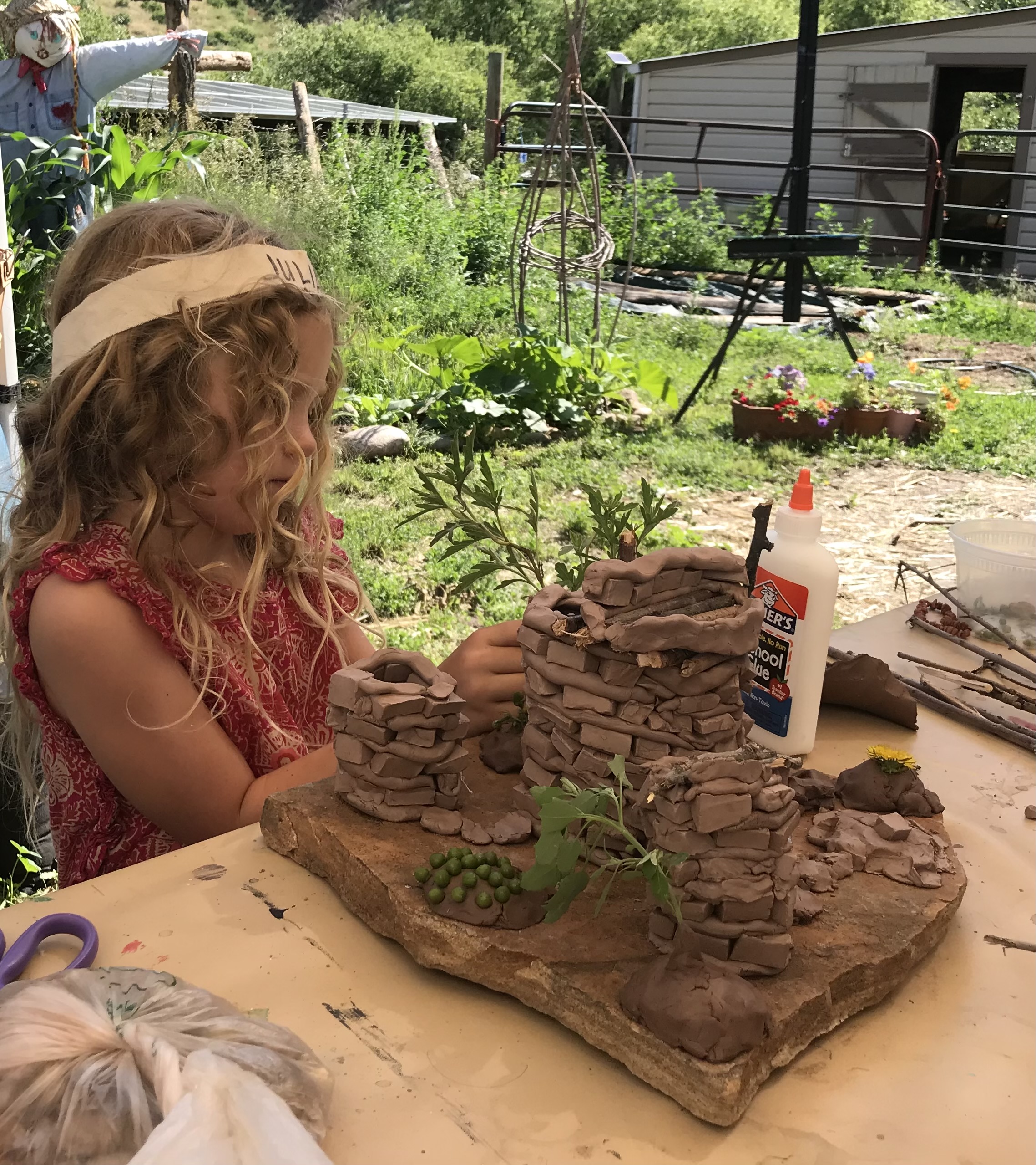 Landscaping her hand crafted homestead